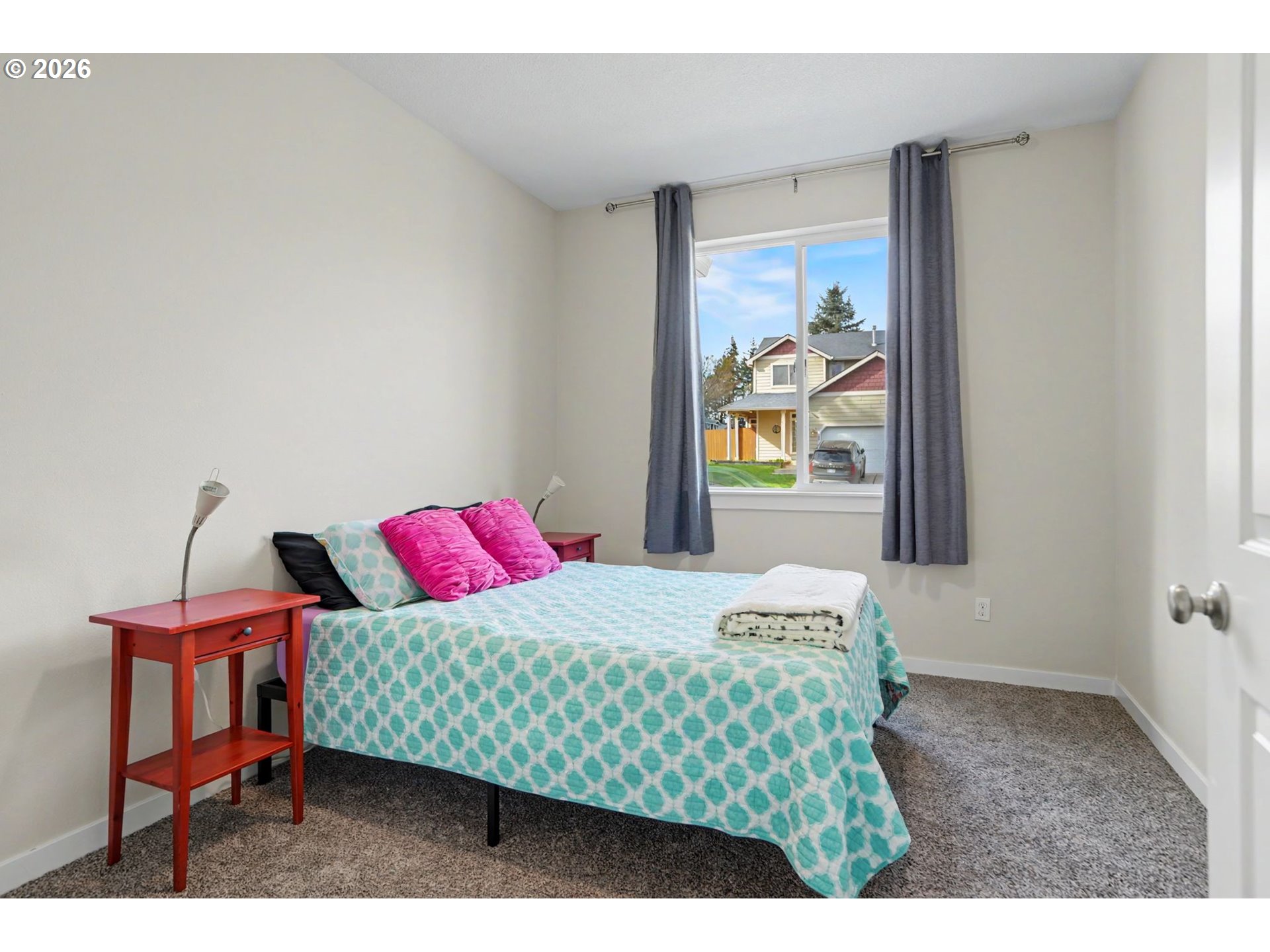 415 Northwest 6th Street Willamina, OR 97396 - Photo 21 of 34 a bedroom with a bed and a table in it