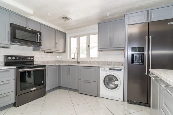 a kitchen with granite countertop cabinets and steel stainless steel appliances