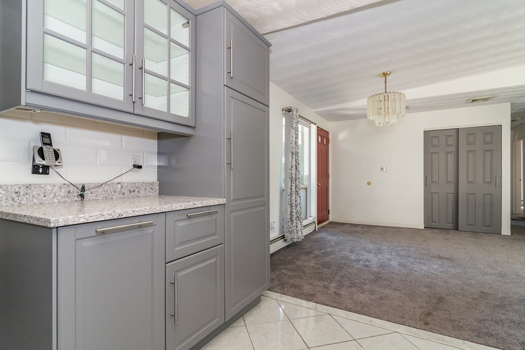 14 Rosslare Road, Unit 14 Framingham, MA 01701 - Photo 4 of 20 a kitchen with stainless steel appliances granite countertop a sink and cabinets