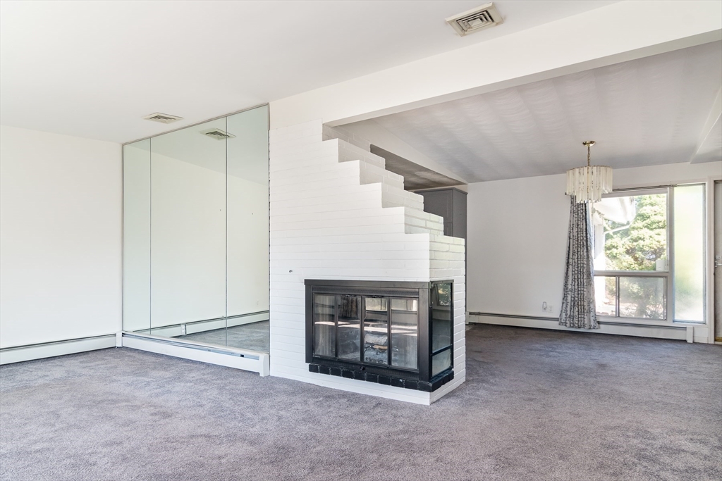 14 Rosslare Road, Unit 14 Framingham, MA 01701 - Photo 9 of 20 a view of an empty room with a fireplace and a window