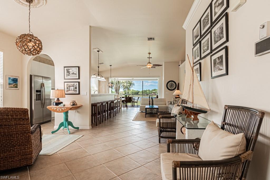 1965 Crestview Way, Unit 156 Naples, FL 34119 - Photo 1 of 45 a living room with patio furniture and a chandelier