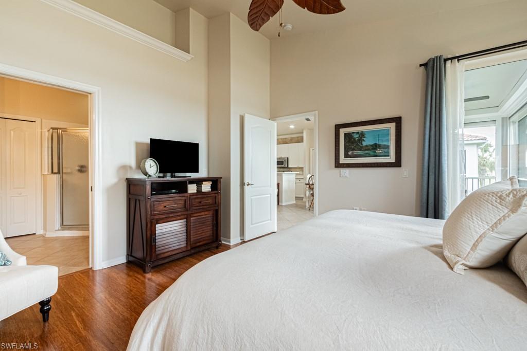 1965 Crestview Way, Unit 156 Naples, FL 34119 - Photo 16 of 45 a bedroom with a bed and flat screen tv