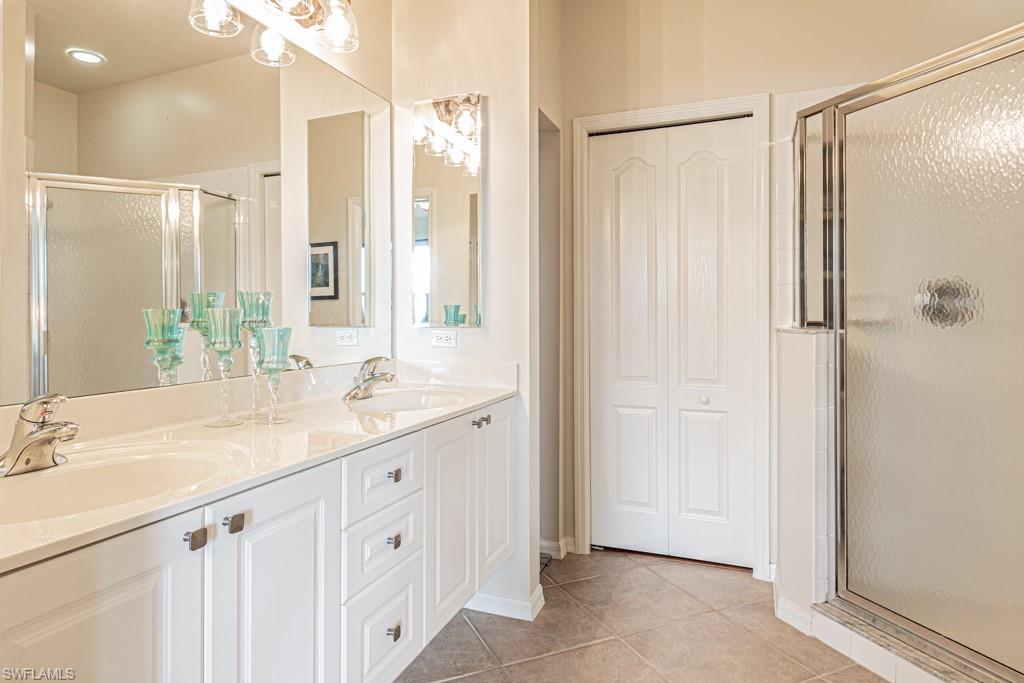1965 Crestview Way, Unit 156 Naples, FL 34119 - Photo 18 of 45 a bathroom with a double vanity sink and mirror