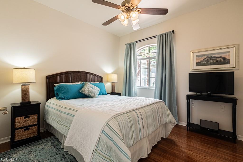 1965 Crestview Way, Unit 156 Naples, FL 34119 - Photo 19 of 45 a bedroom with a bed and a flat screen tv