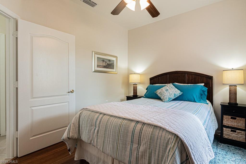 1965 Crestview Way, Unit 156 Naples, FL 34119 - Photo 20 of 45 a bedroom with a bed and a lamp