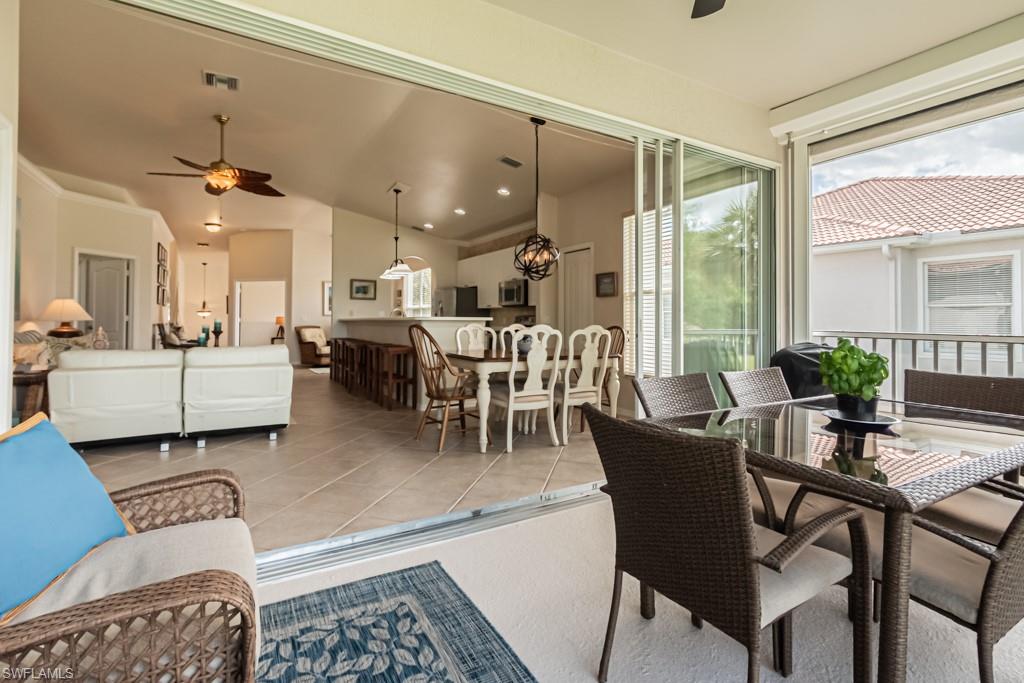 1965 Crestview Way, Unit 156 Naples, FL 34119 - Photo 30 of 45 a living room with furniture and a large window