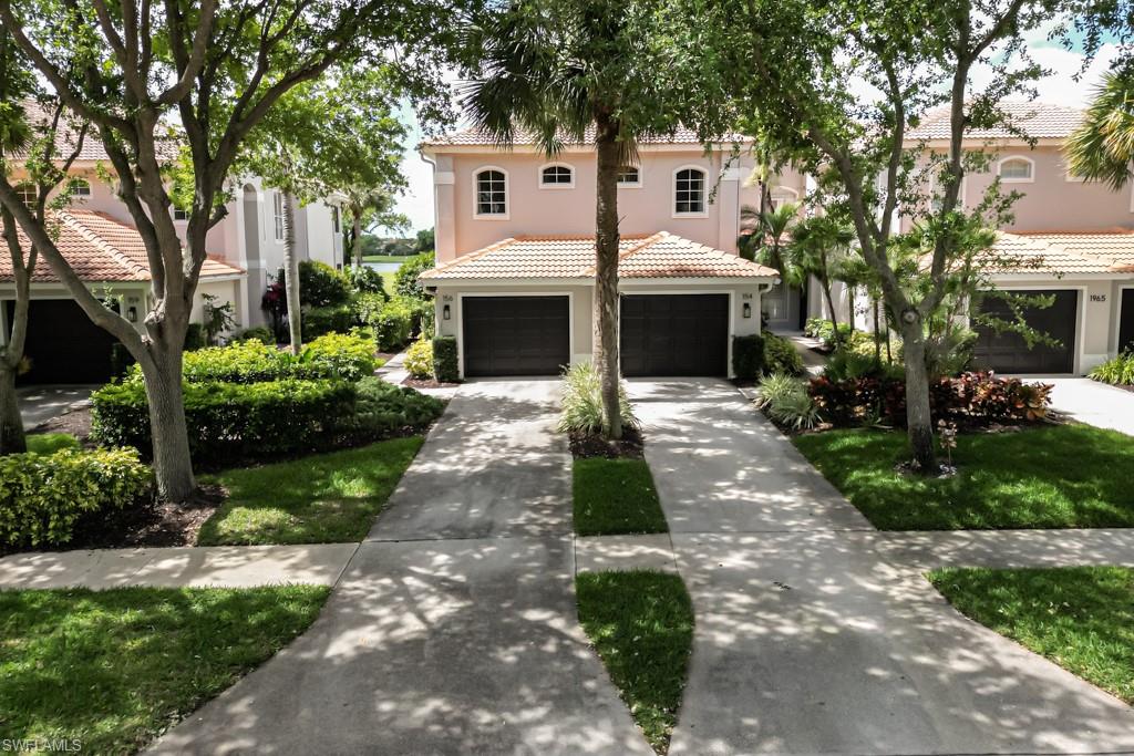 1965 Crestview Way, Unit 156 Naples, FL 34119 - Photo 35 of 45 a front view of a house with a garden and trees