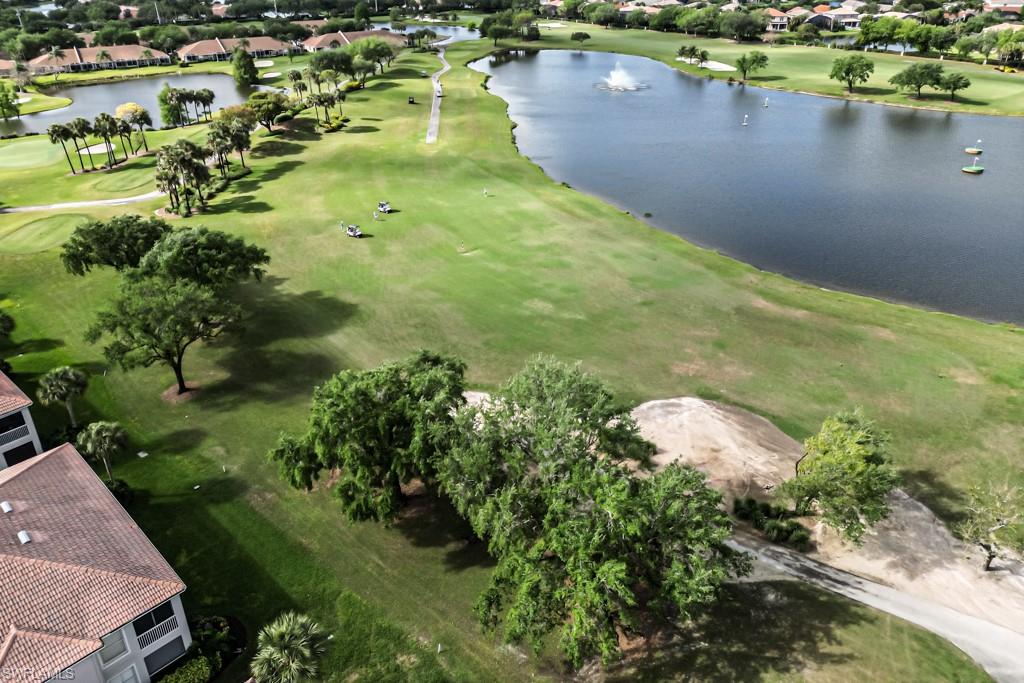 1965 Crestview Way, Unit 156 Naples, FL 34119 - Photo 39 of 45 a view of a lake with green space