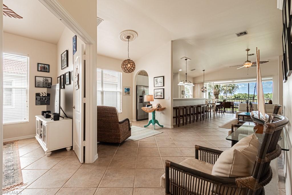 1965 Crestview Way, Unit 156 Naples, FL 34119 - Photo 4 of 45 a living room with furniture and a chandelier