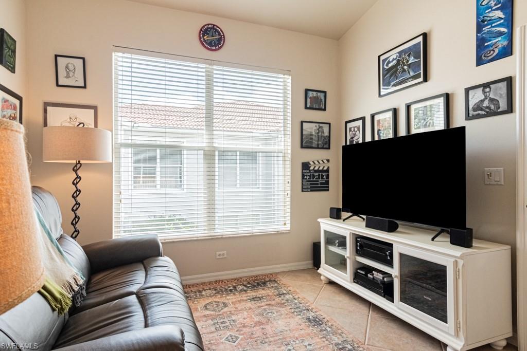 1965 Crestview Way, Unit 156 Naples, FL 34119 - Photo 10 of 45 a living room with furniture and a flat screen tv