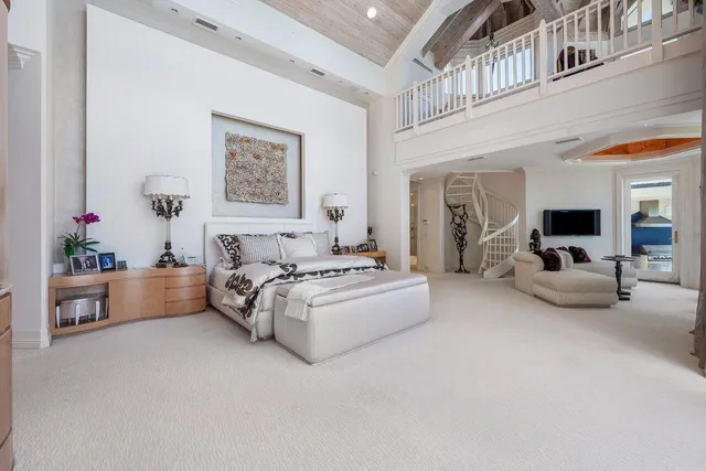 a view of staircase with lots of frames on wall and a window