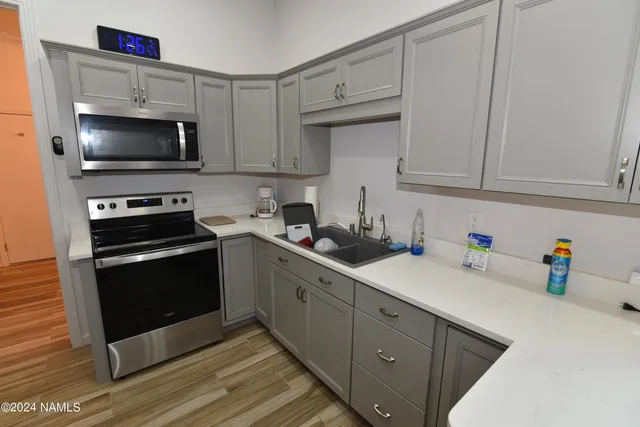 a kitchen with a sink and a stove top oven