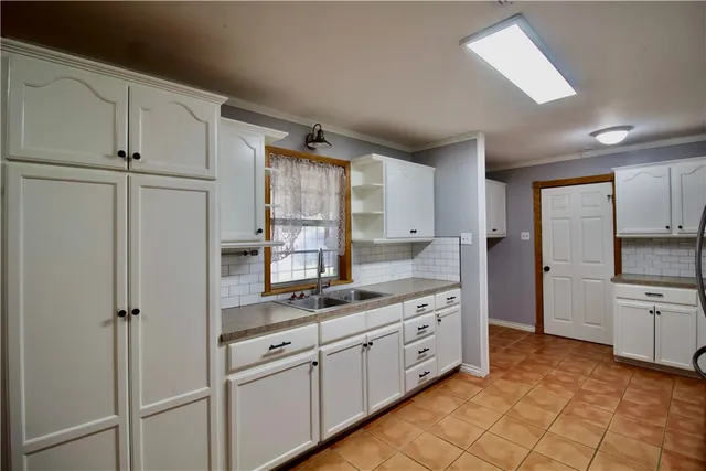 a kitchen with white cabinets and white appliances