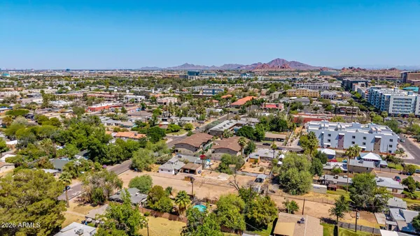 an aerial view of residential houses with outdoor space
