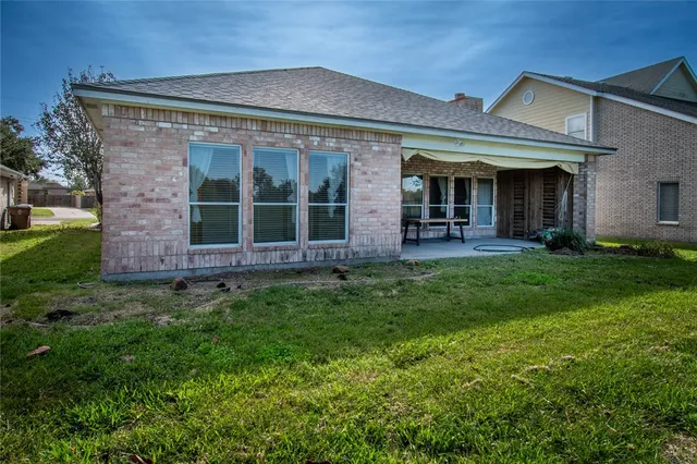 front view of a brick house with a yard