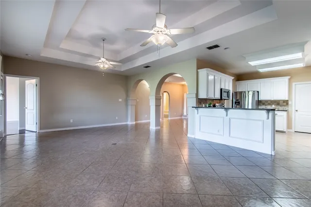 a view of a kitchen with a sink and a chandelier fan