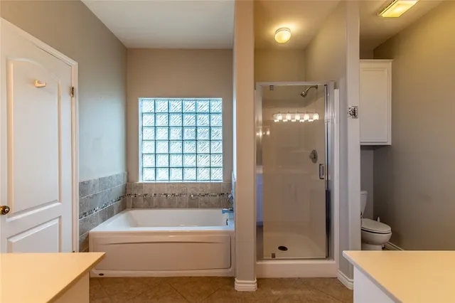 a bathroom with a bathtub and shower