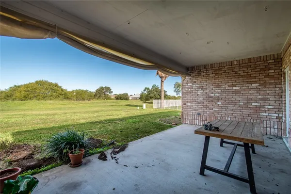 a backyard of a house with outdoor seating and lake view