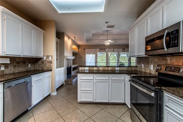 a kitchen with stainless steel appliances granite countertop a sink and stove top oven