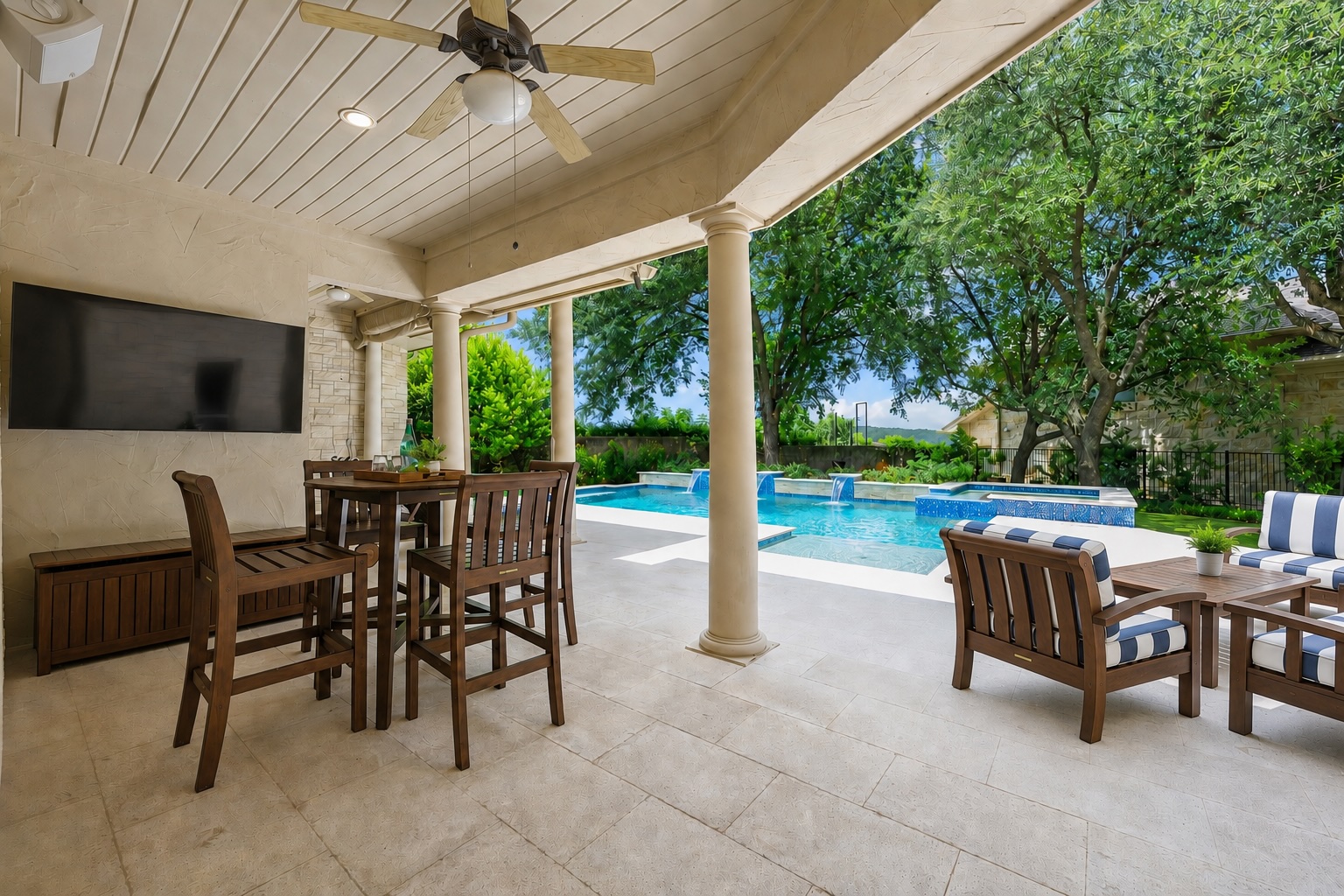 5200 Rico Cove Austin, TX 78731 - Photo 34 of 40 An inviting covered patio featuring robust support columns and polished stone flooring overlooks the pool.