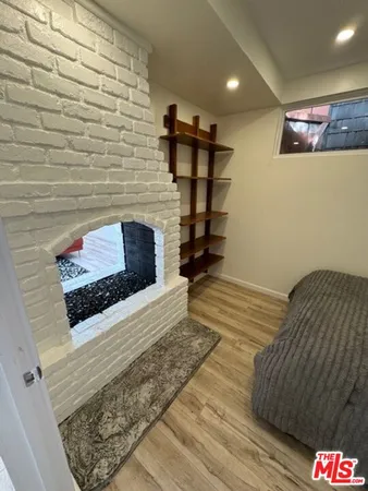 a hallway with front door and wooden floor