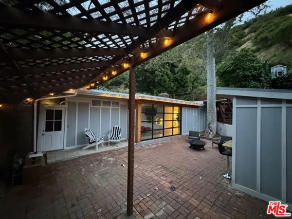a view of a porch with furniture and floor to ceiling window