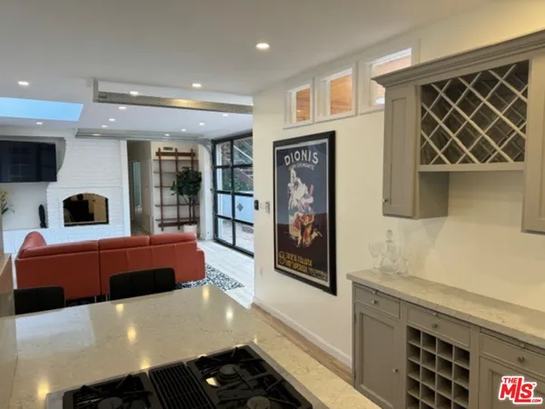 a large kitchen with stainless steel appliances a stove and a refrigerator