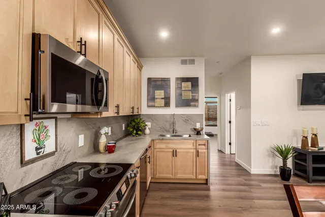 an aerial view of residential houses with outdoor space and parking