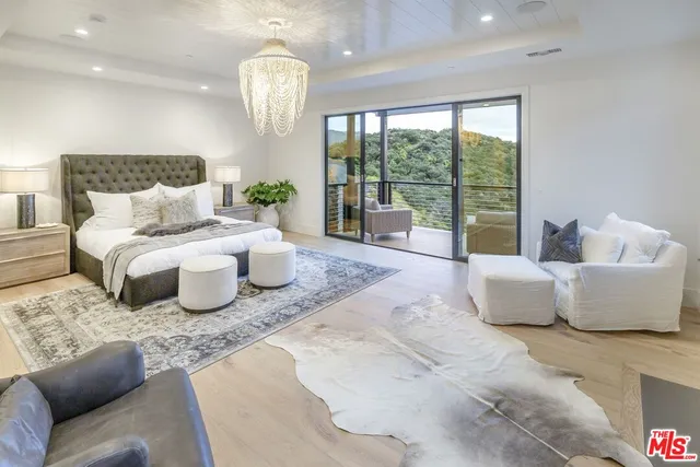 a bedroom with a bed and glass window