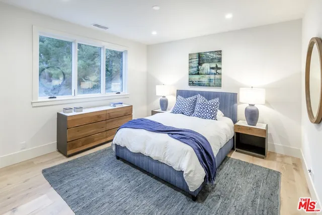 a living room with furniture a rug and a window