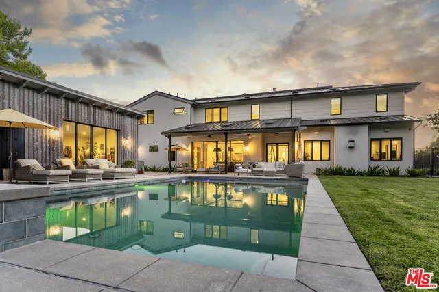 a front view of a house with a yard table and chairs