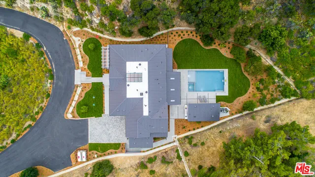 a view of an house with swimming pool and sitting area