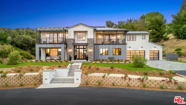 a front view of a house with a yard table and chairs