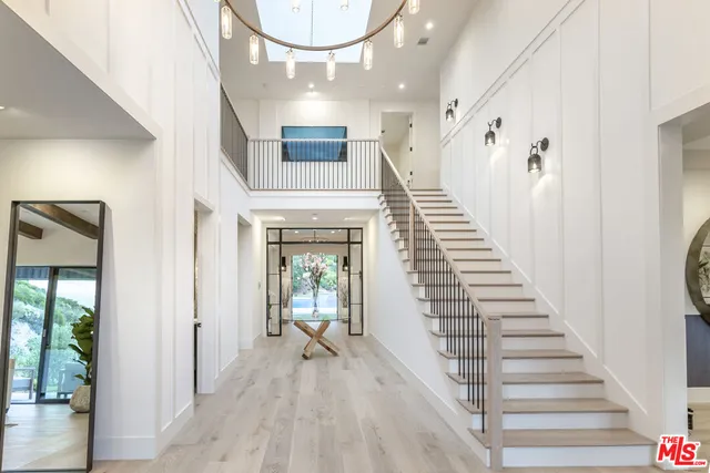 a view of an entryway with wooden floor