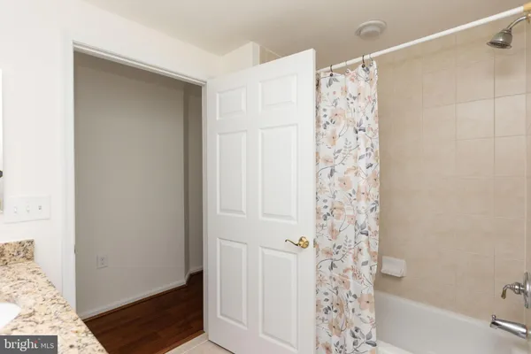 a bathroom with a shower curtain and a window