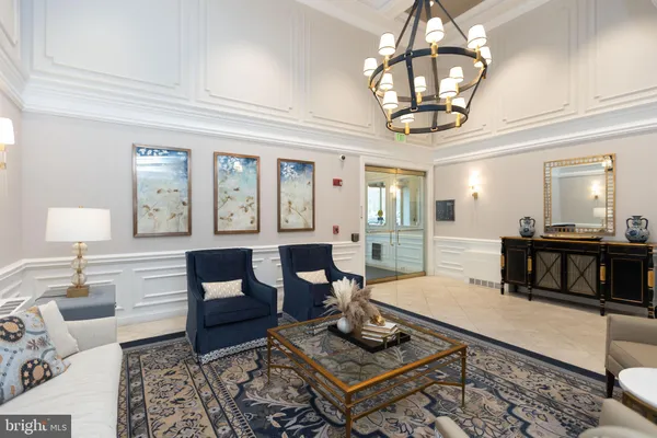 a living room with fireplace furniture and a chandelier