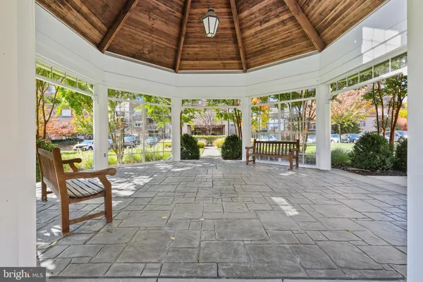 a view of a porch with furniture and floor to ceiling window