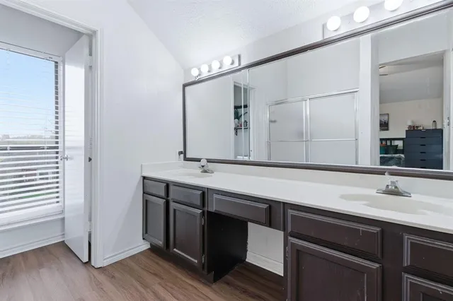 a bathroom with a double vanity sink and a mirror