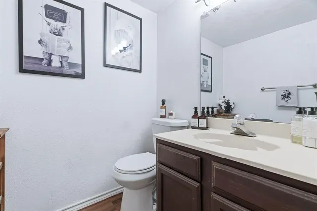 a bathroom with a sink mirror and toilet