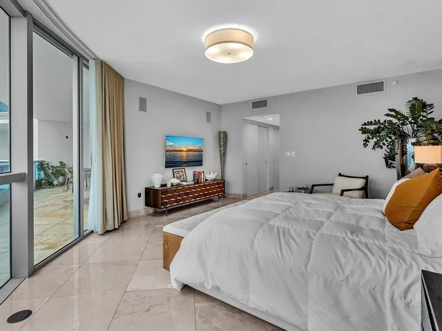 a bathroom with a tub a sink and mirror