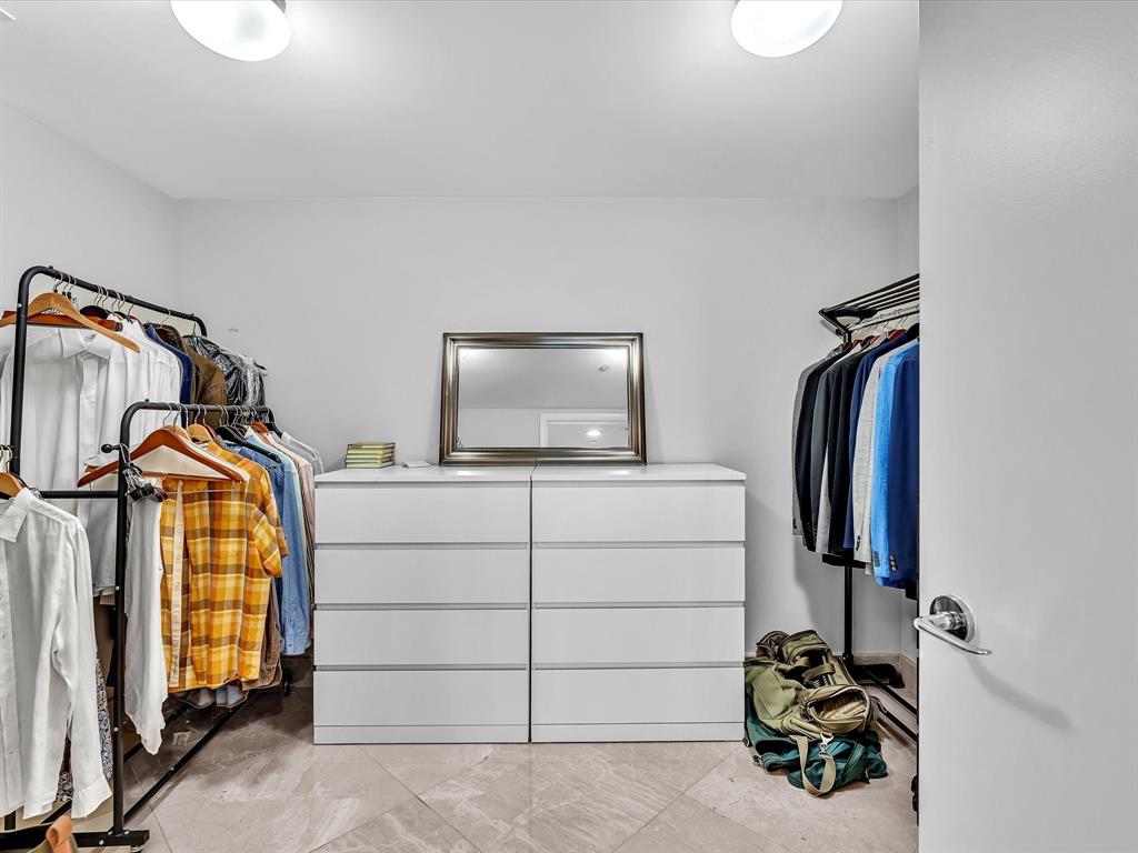 1600 South Ocean Boulevard, Unit 403 Pompano Beach, FL 33062 - Photo 13 of 52 a view of walk in closet with clothes and shoes