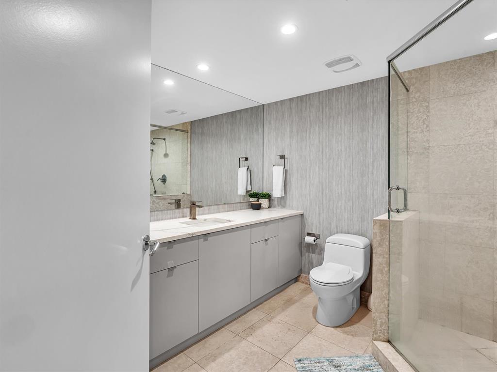 1600 South Ocean Boulevard, Unit 403 Pompano Beach, FL 33062 - Photo 14 of 52 a bathroom with a toilet sink and mirror