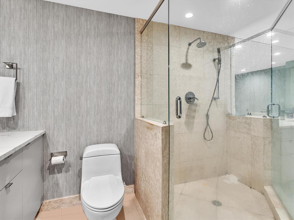 1600 South Ocean Boulevard, Unit 403 Pompano Beach, FL 33062 - Photo 15 of 52 a white toilet sitting next to a bathroom sink