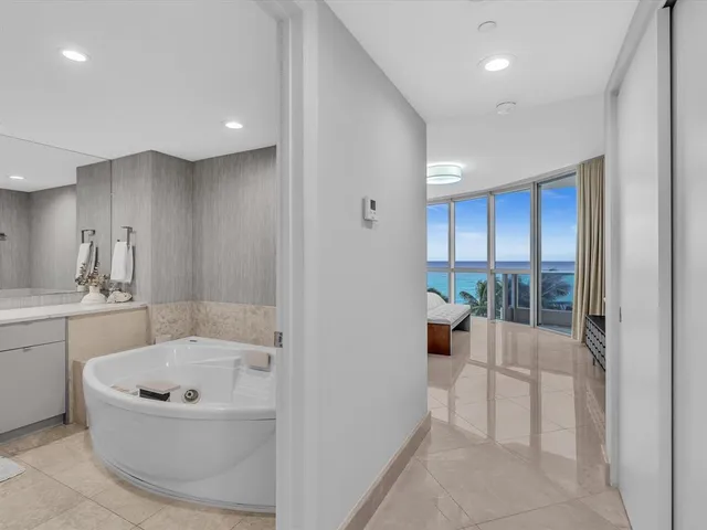 a bathroom with a granite countertop sink a toilet and a mirror