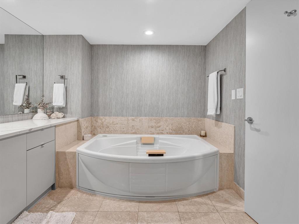 1600 South Ocean Boulevard, Unit 403 Pompano Beach, FL 33062 - Photo 18 of 52 a bathroom with a tub a sink and mirror