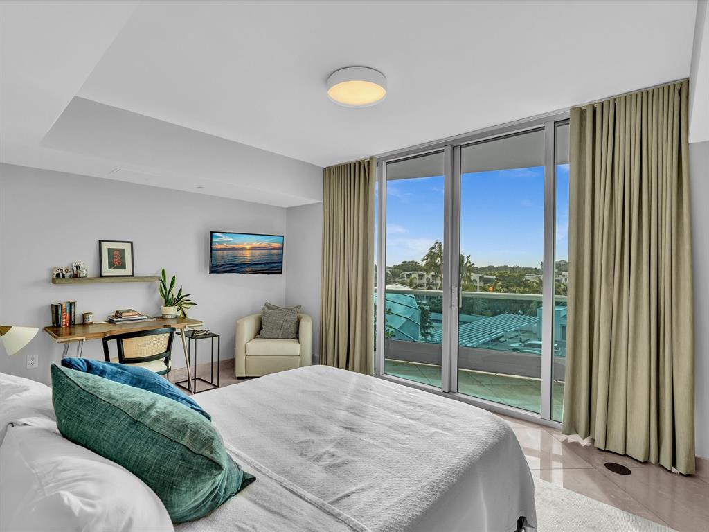 1600 South Ocean Boulevard, Unit 403 Pompano Beach, FL 33062 - Photo 20 of 52 a bedroom with a bed and a large window