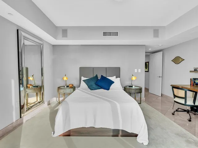 a living room with fireplace furniture and a large window