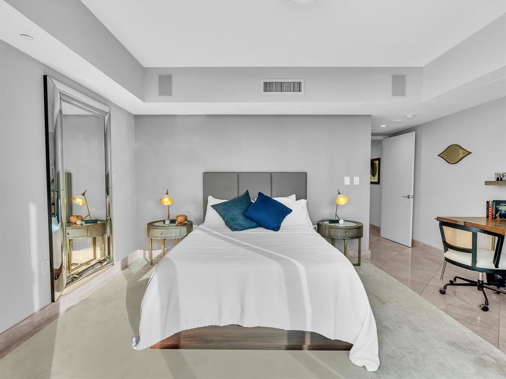 1600 South Ocean Boulevard, Unit 403 Pompano Beach, FL 33062 - Photo 21 of 52 a bedroom with a bed and a table in it