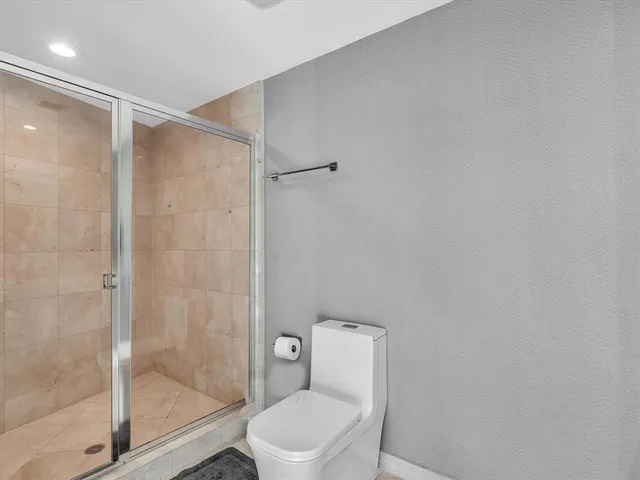 a bathroom with a shower and a toilet
