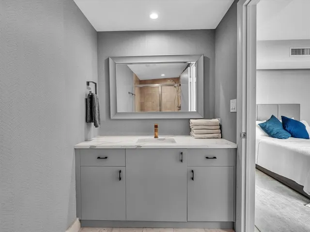 a living room with furniture potted plant and a large window